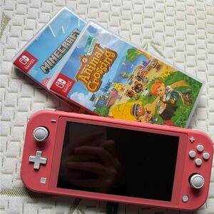 Nintendo Switch Lite Pink Handheld Console with two games, charger and box